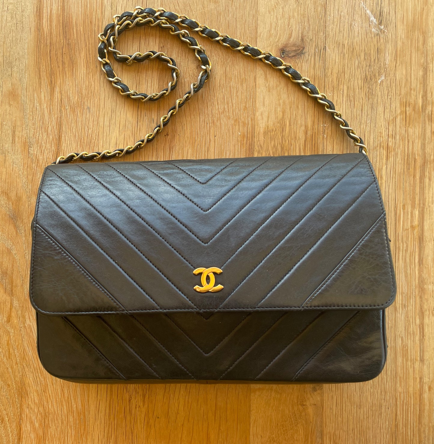 Chanel Wallet on Chain handbag in black lamb leather and chevron pattern.